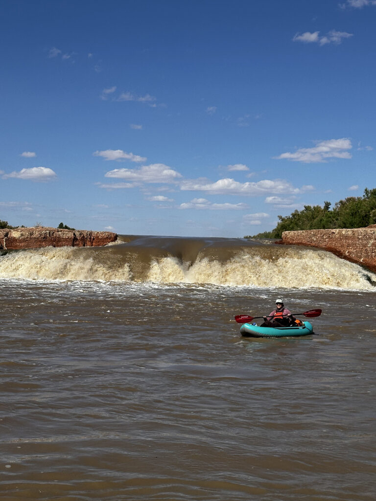 A boater in front of a waterfall.